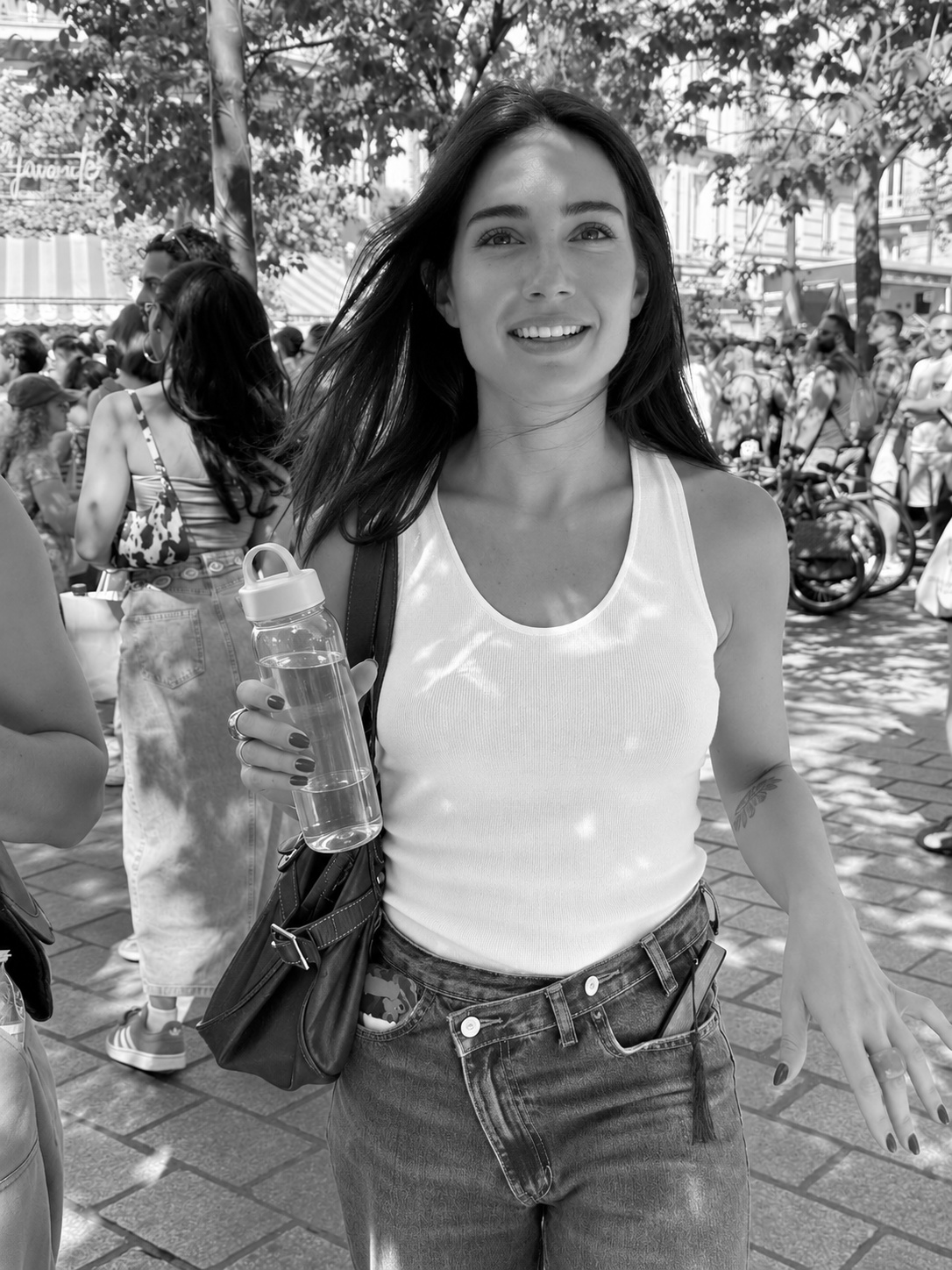 Black-and-white portrait of Romane holding a water bottle